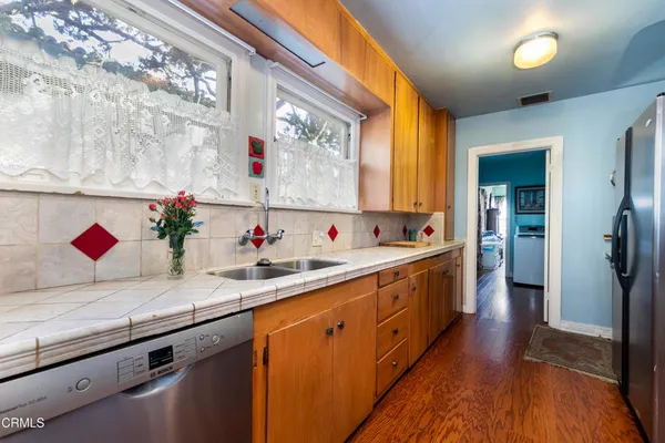 a kitchen with cabinets and a potted plant
