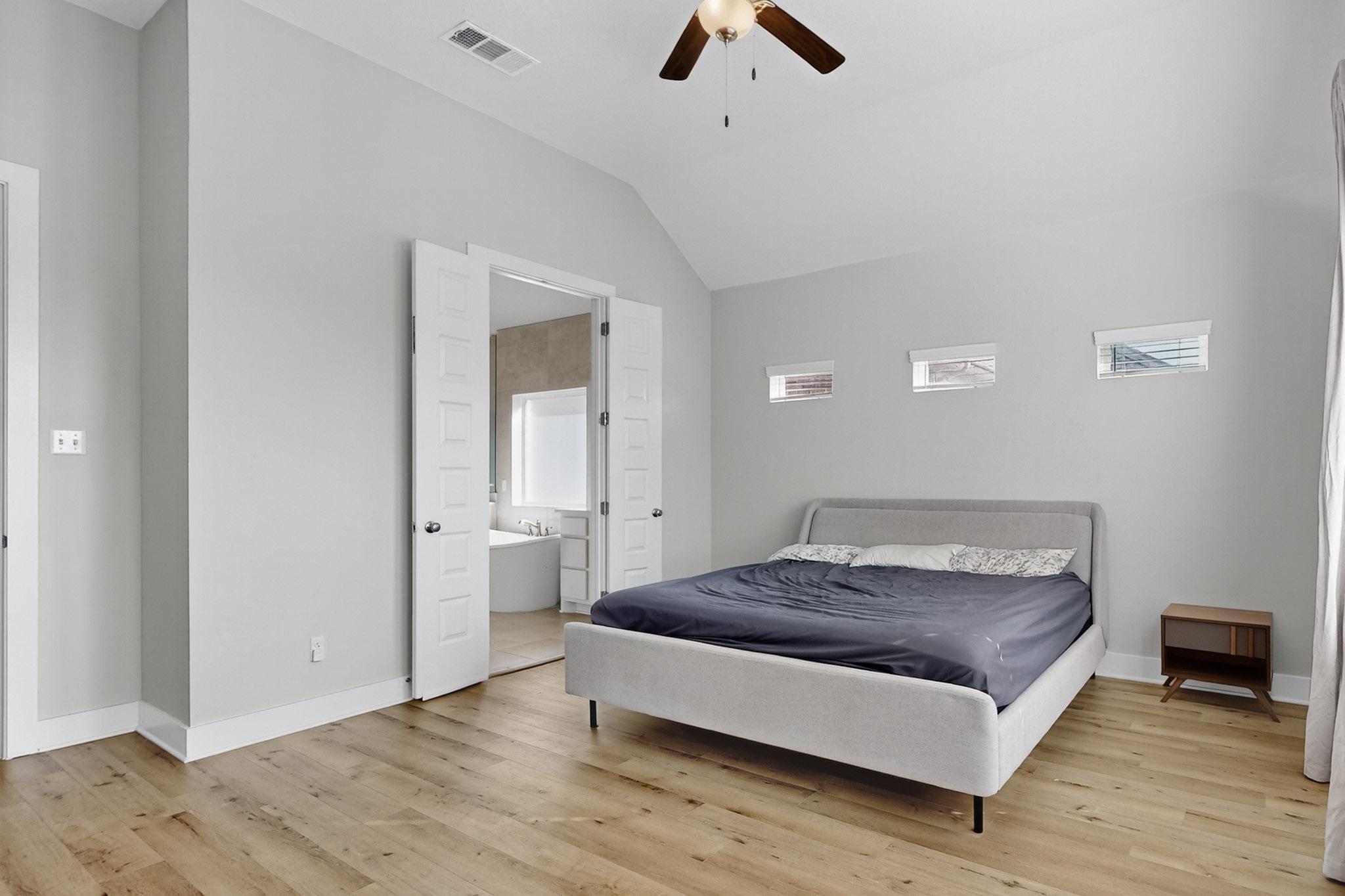 20912 Carries Ranch Road Pflugerville, TX 78660 - Photo 11 of 20 High vaulted ceilings and rich wood floors define this tranquil bedroom space.