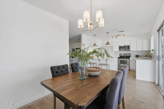 a view of a dining room with furniture and a chandelier