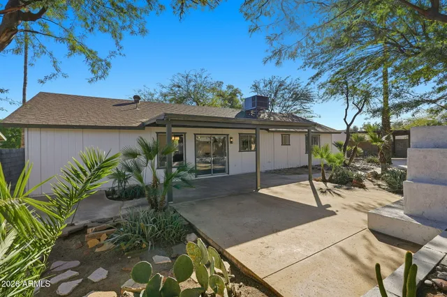 a view of a house with a small yard and potted plants