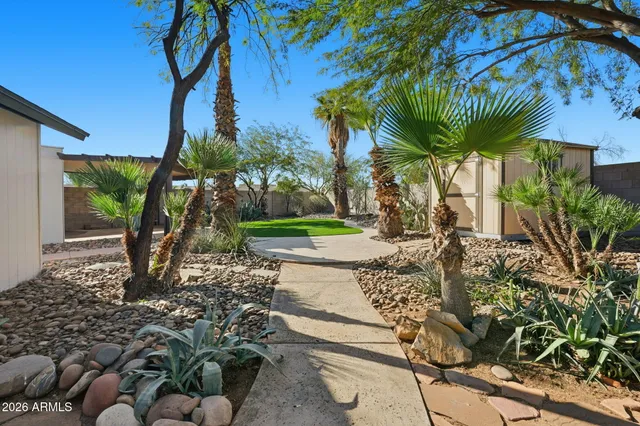 a view of a porch with a table chairs under an umbrella