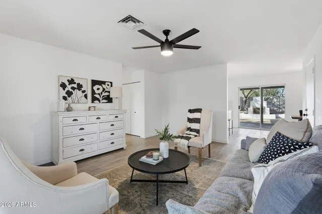 a living room with furniture and a wooden floor