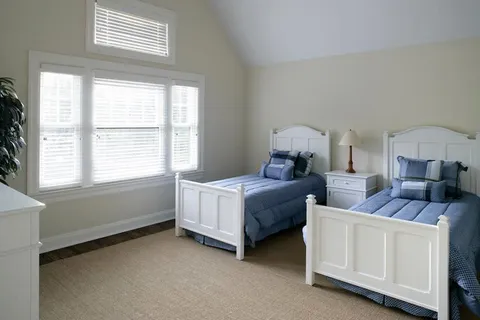 a bed room with a bed and a window