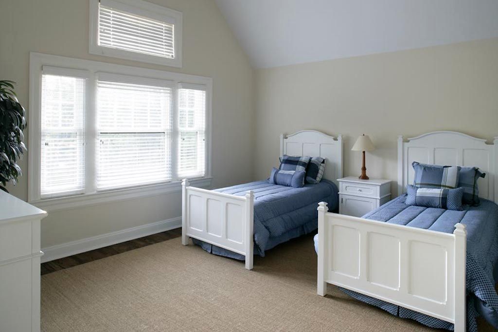 Undisclosed Address Quogue, NY 11959 - Photo 12 of 19 a bed room with a bed and a window