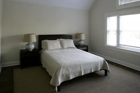 a bedroom with a bed and window