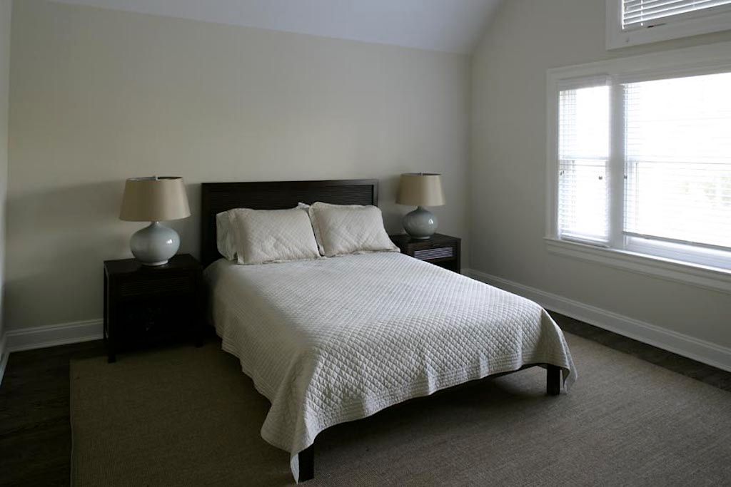 Undisclosed Address Quogue, NY 11959 - Photo 13 of 19 a bedroom with a bed and window