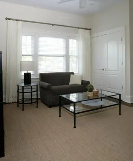 a view of house with a big yard and potted plants
