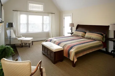 a bedroom with bed and a window