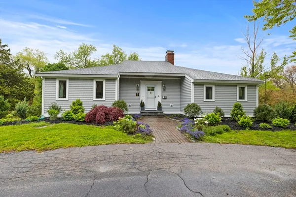 a front view of a house with a garden