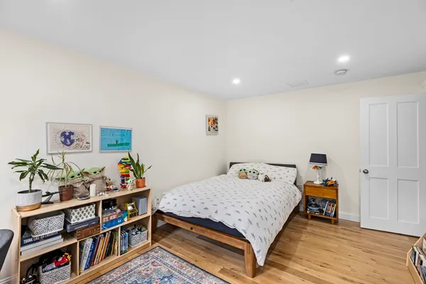a bedroom with furniture and a book shelf