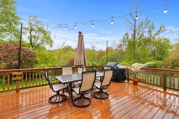 a view of a balcony with furniture and wooden floor