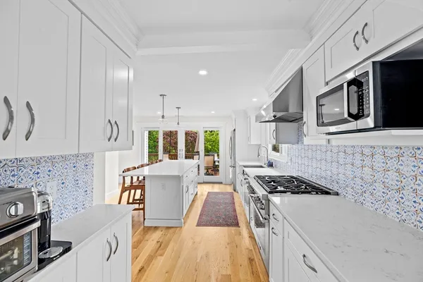 a kitchen with a stove a sink and a microwave