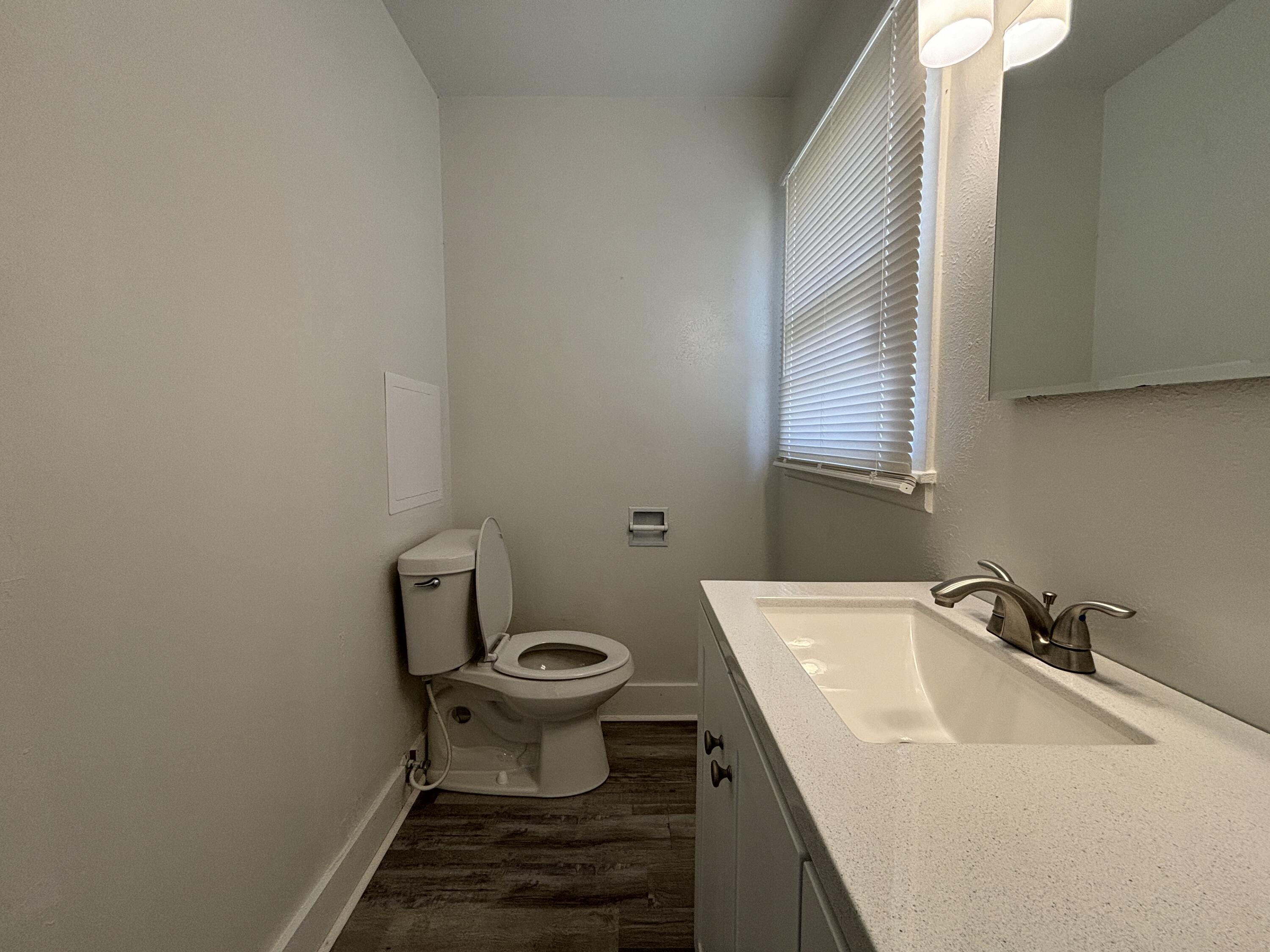 1303 46th Street Lubbock, TX 79412 - Photo 11 of 13 a bathroom with a sink and a toilet