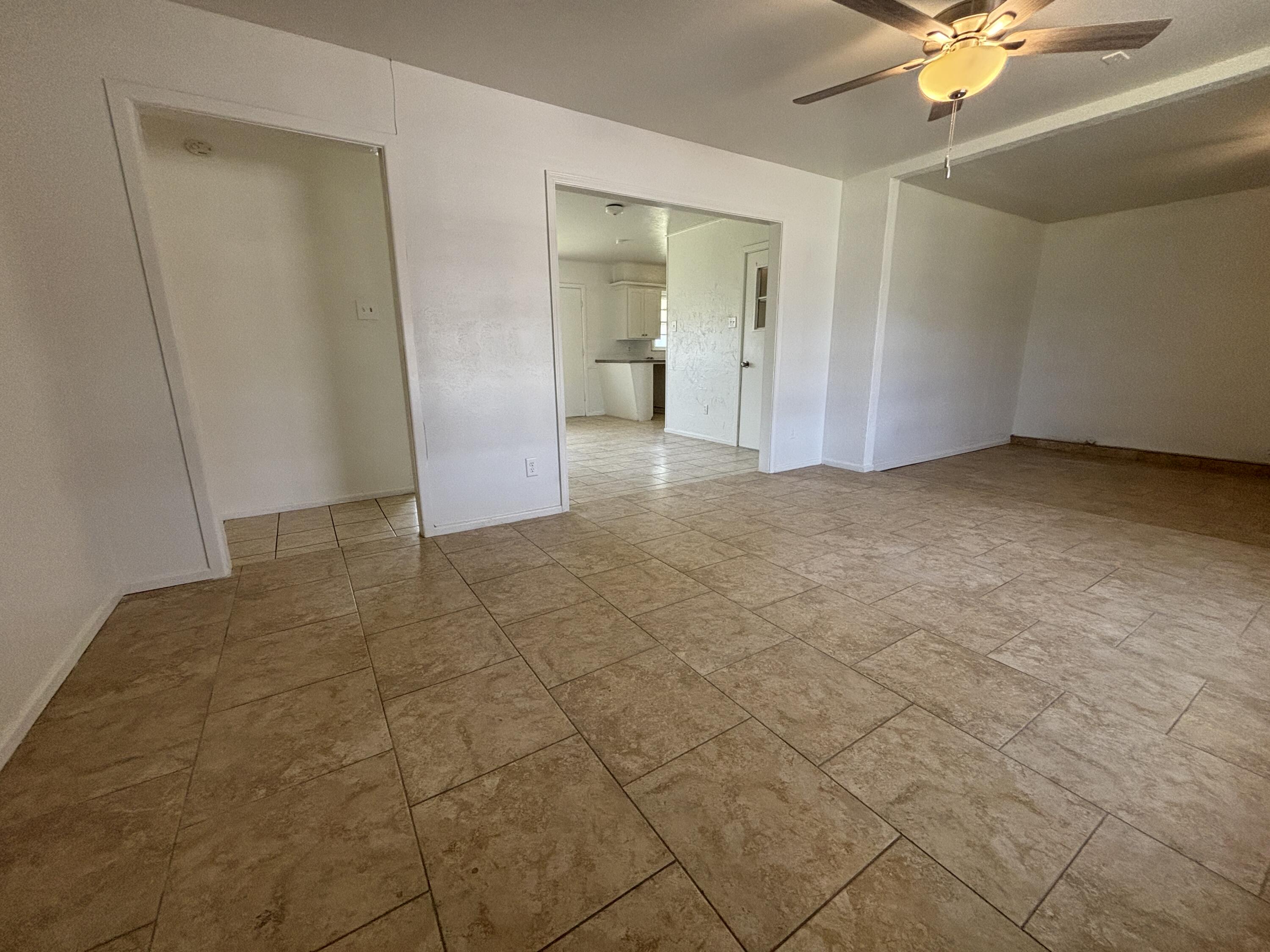1303 46th Street Lubbock, TX 79412 - Photo 3 of 13 a view of an empty room and chandelier fan