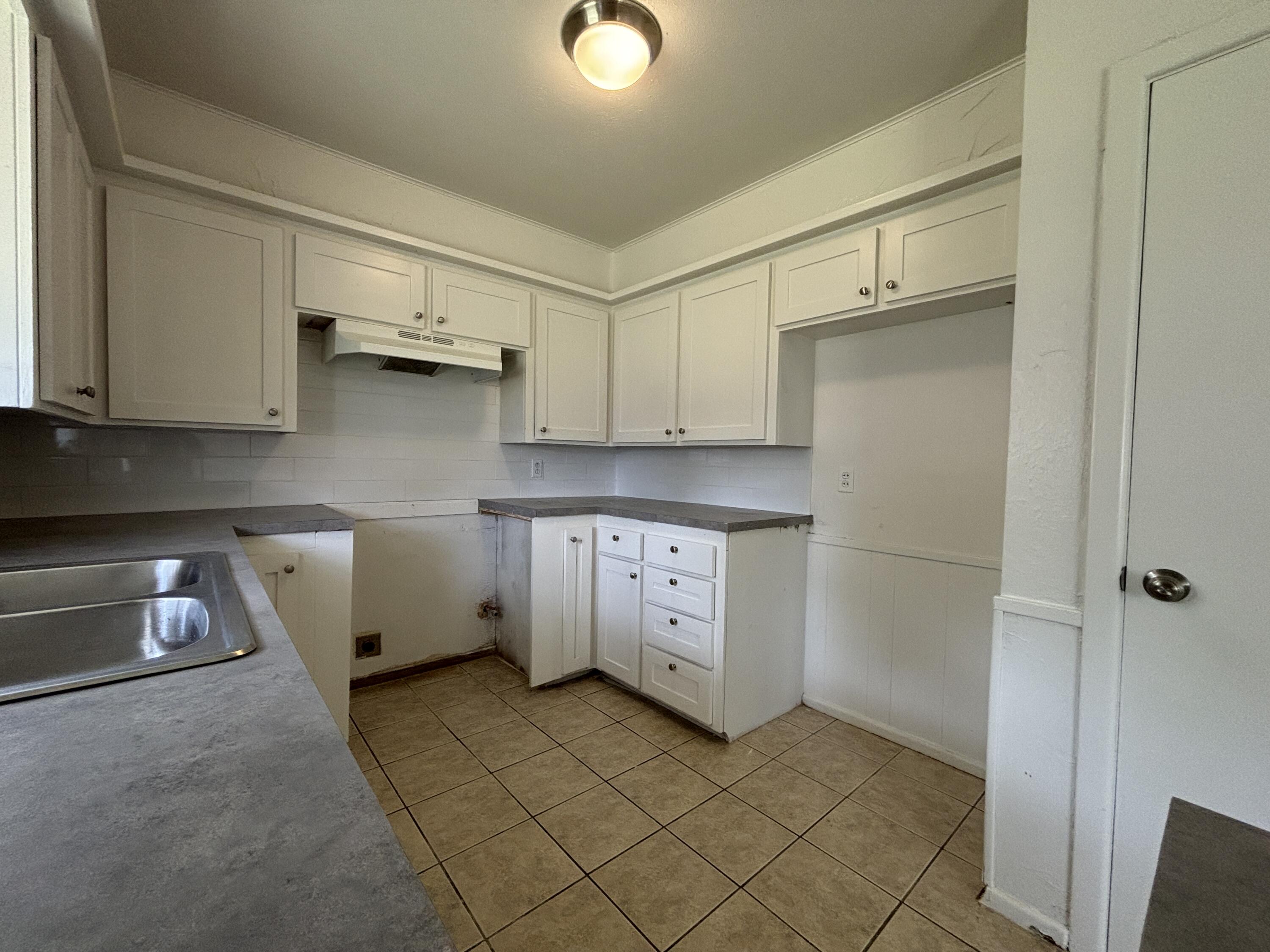 1303 46th Street Lubbock, TX 79412 - Photo 6 of 13 a view of cabinets and wooden floor