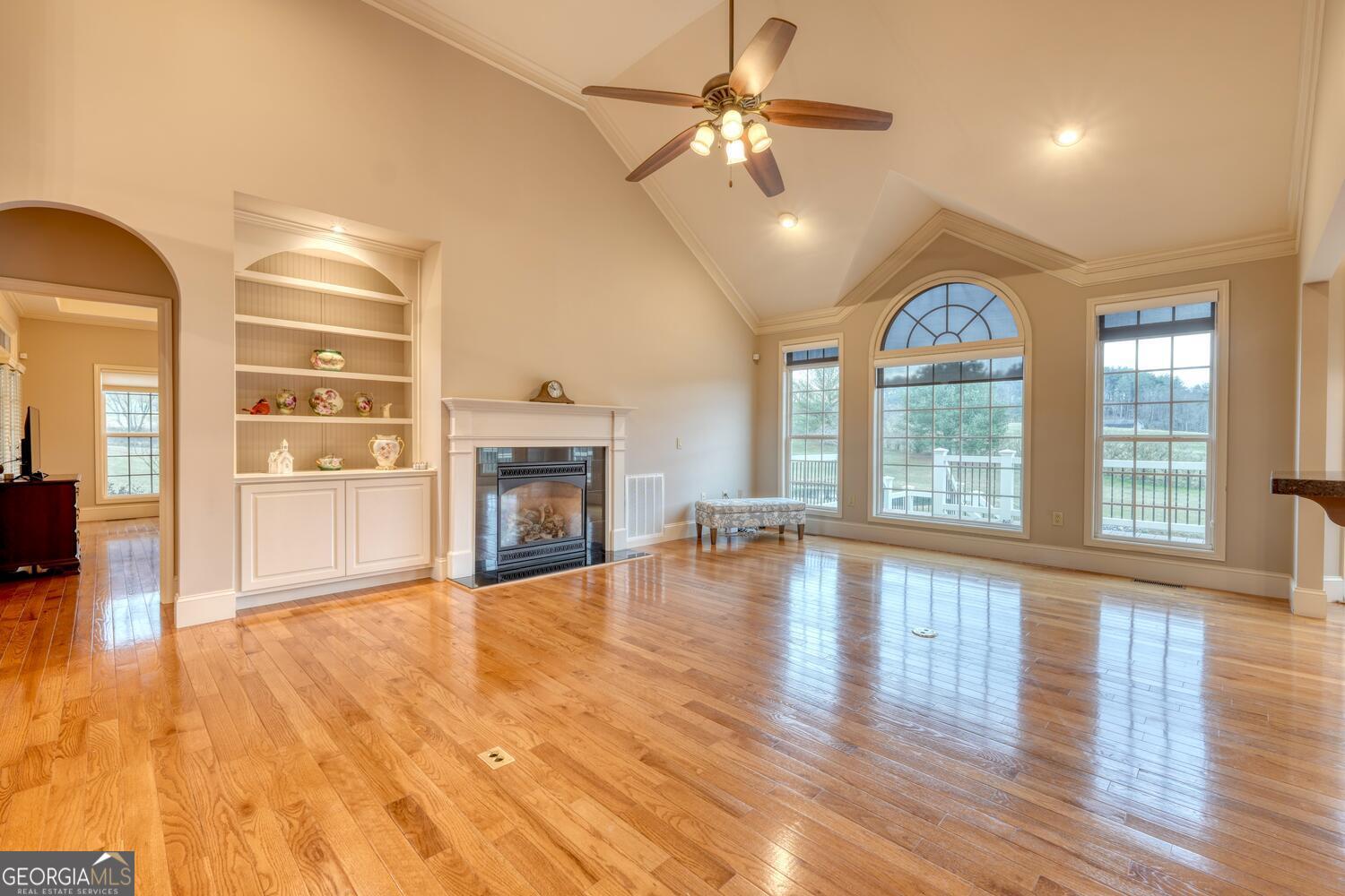 178 Barnwood Road Blairsville, GA 30512 - Photo 21 of 66 wooden floor fireplace and windows in an empty room