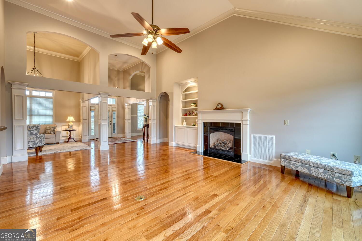 178 Barnwood Road Blairsville, GA 30512 - Photo 22 of 66 a view of an empty room with wooden floor a fireplace and a window