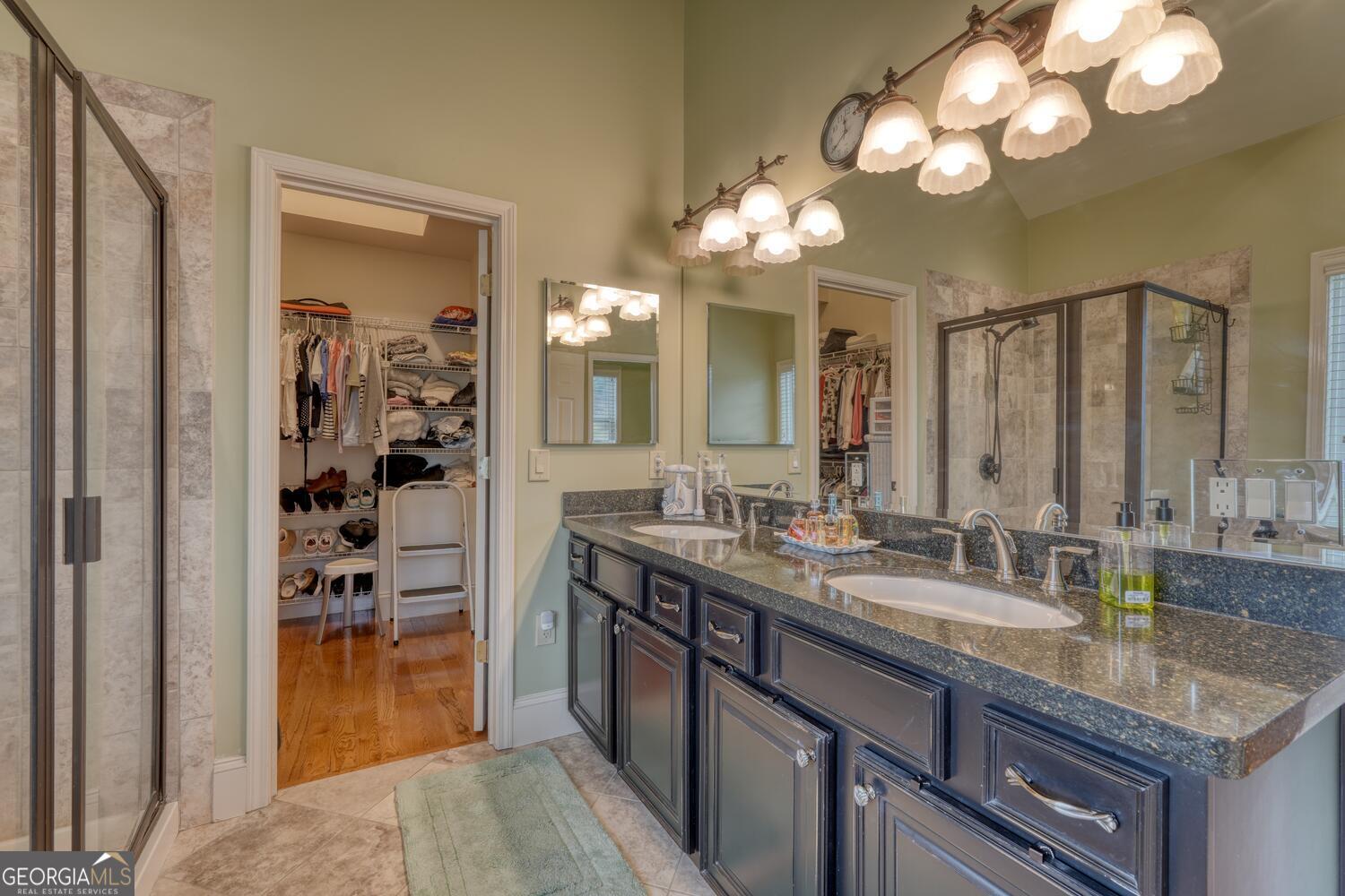 178 Barnwood Road Blairsville, GA 30512 - Photo 36 of 66 a bathroom with a granite countertop sink a large mirror and a shower