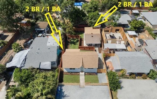 an aerial view of residential houses with outdoor space