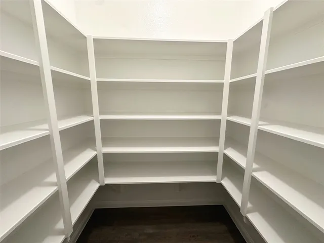 a view of walk in closet with empty racks