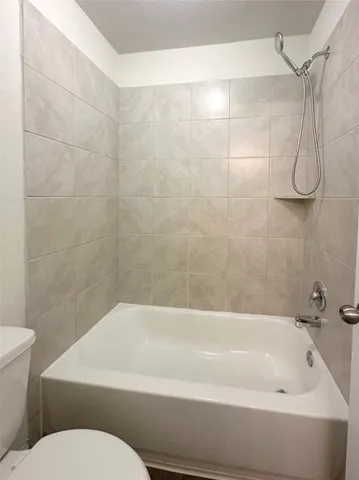 a bathroom with a bathtub and a toilet