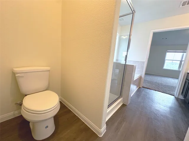 a white toilet sitting next to a bathroom sink