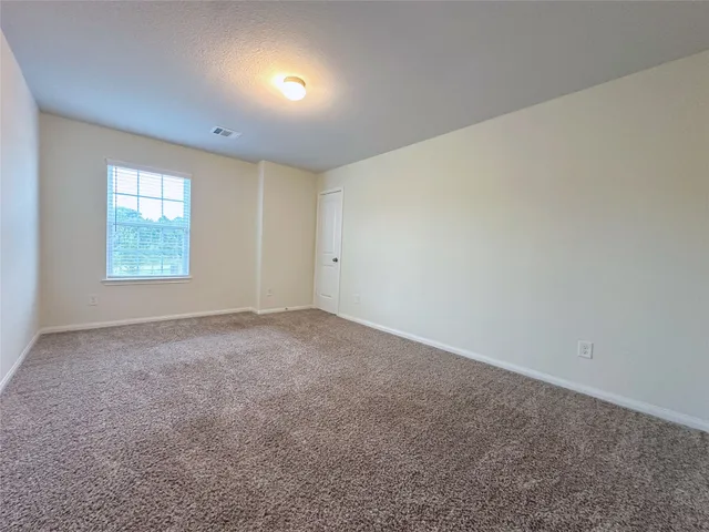 an empty room with a empty space and windows