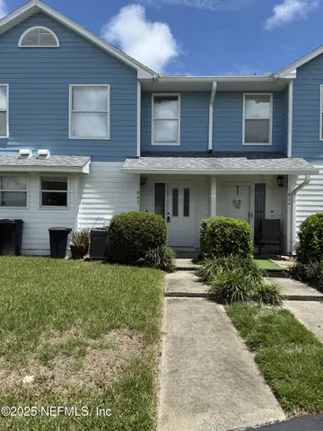 a view of a house with a yard and plants