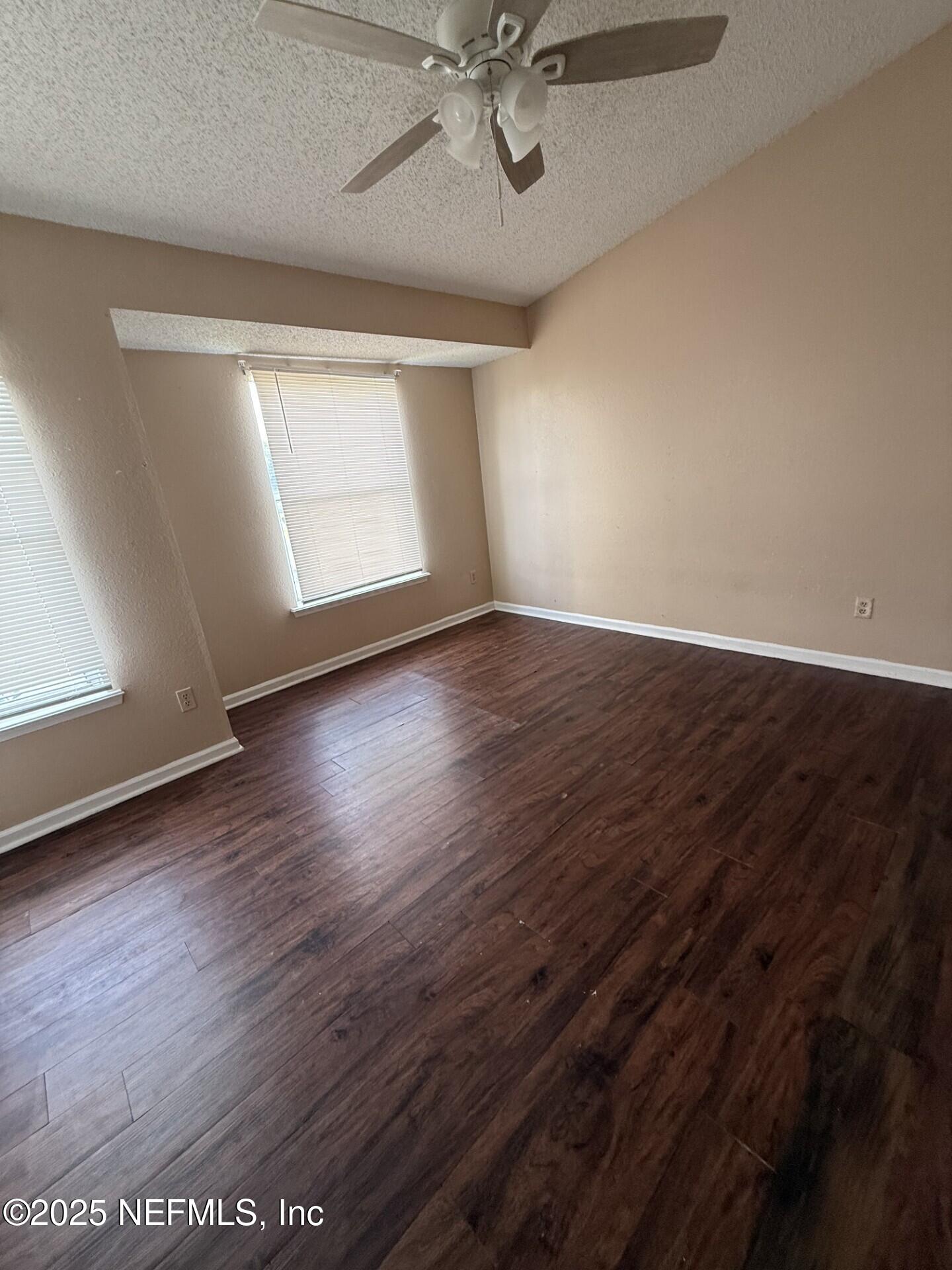 791 Assisi Lane, Unit 803 Jacksonville, FL 32233 - Photo 10 of 15 wooden floor in an empty room with a window