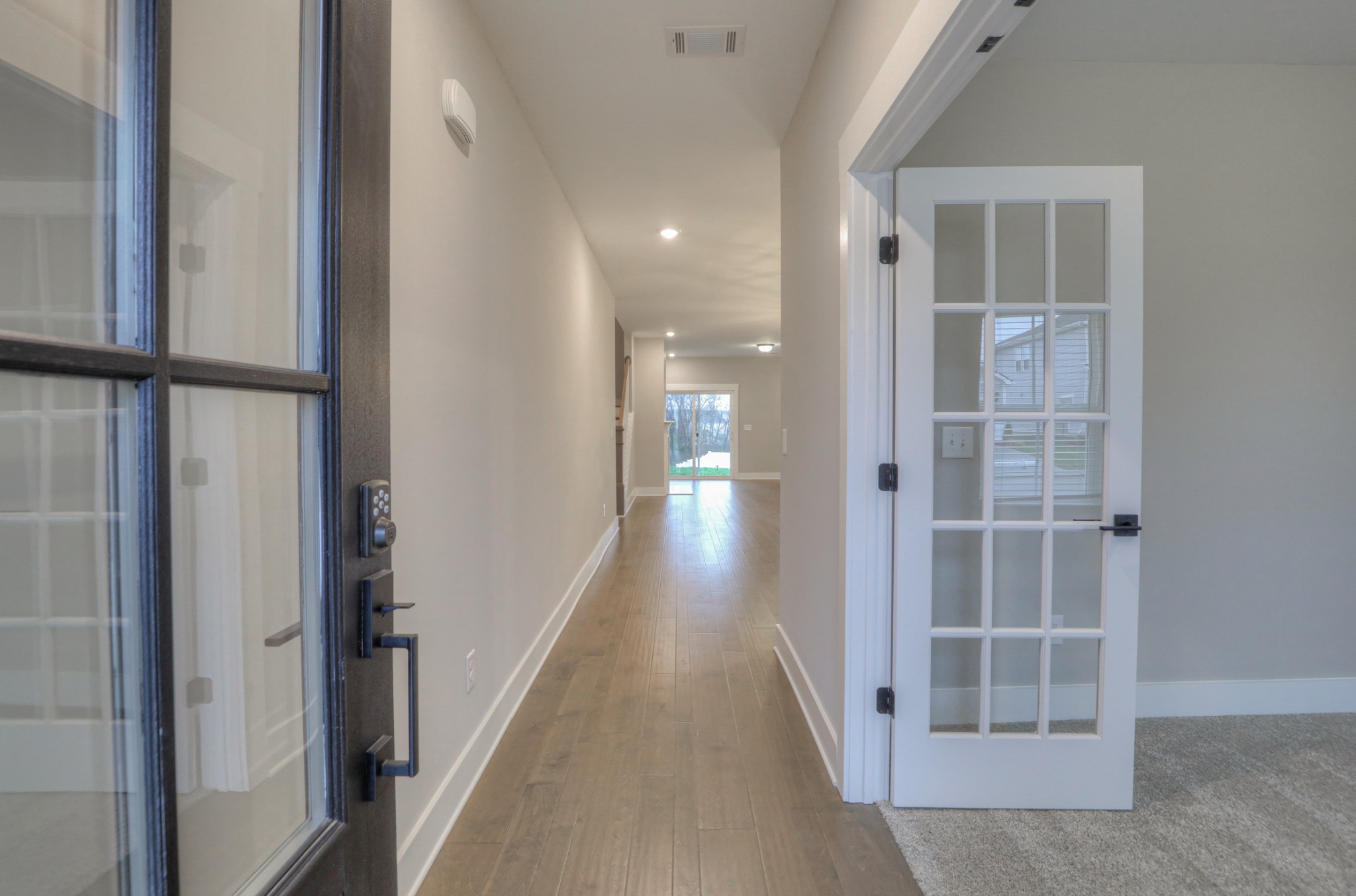 724 Castle Road Mount Juliet, TN 37122 - Photo 4 of 52 a view of a hallway with wooden floor and staircase