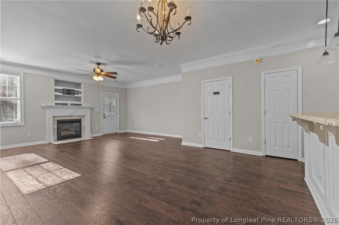 342 Bahama Loop Fayetteville, NC 28314 - Photo 11 of 47 an empty room with windows fireplace and wooden floor