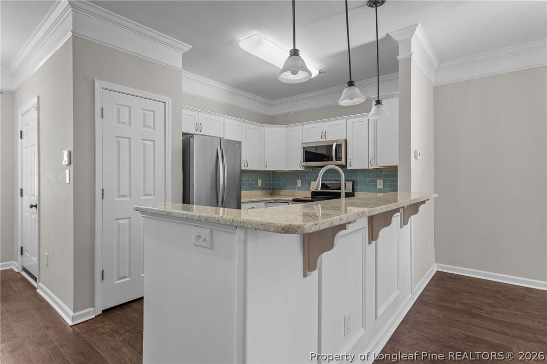 342 Bahama Loop Fayetteville, NC 28314 - Photo 13 of 47 a kitchen with stainless steel appliances granite countertop a sink a stove a refrigerator a center island and cabinets