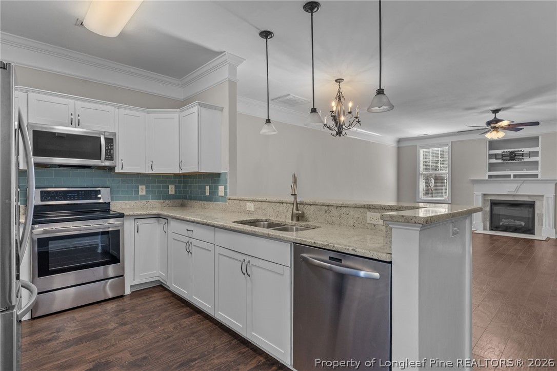 342 Bahama Loop Fayetteville, NC 28314 - Photo 14 of 47 a kitchen with stainless steel appliances granite countertop a stove a sink and a microwave