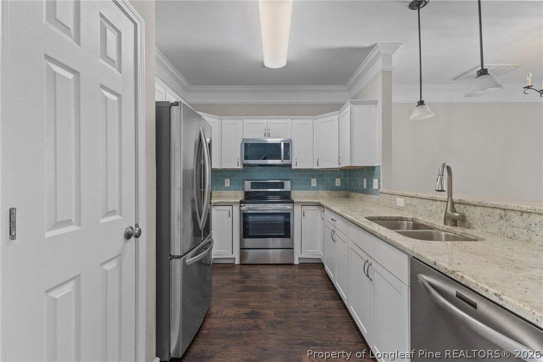 342 Bahama Loop Fayetteville, NC 28314 - Photo 15 of 47 a kitchen with granite countertop a sink stainless steel appliances and white cabinets