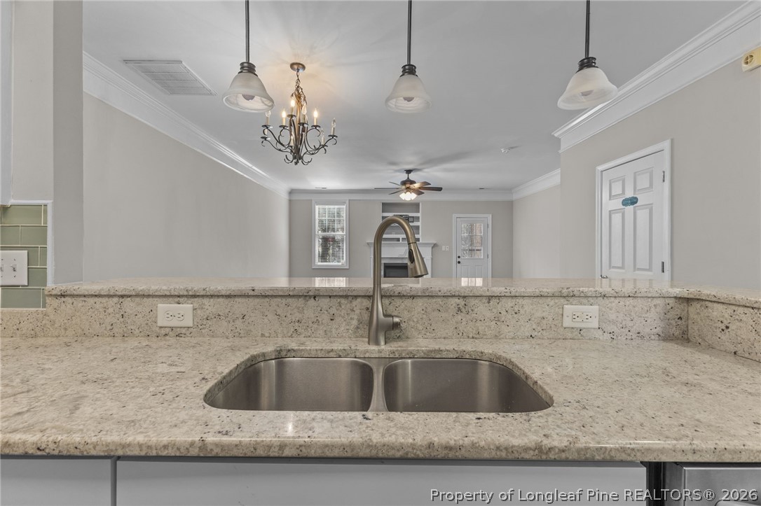 342 Bahama Loop Fayetteville, NC 28314 - Photo 16 of 47 a kitchen with a sink and chandelier