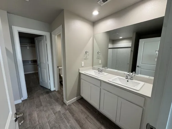 a bathroom with a double vanity sink and a mirror