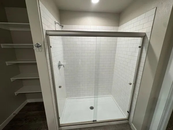 a bathroom with a glass door shower
