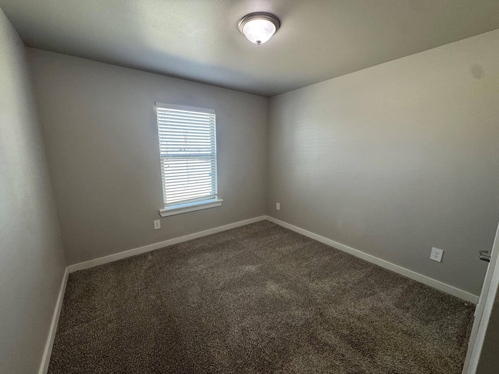 4701 126th Street Lubbock, TX 79424 - Photo 2 of 13 an empty room with a window