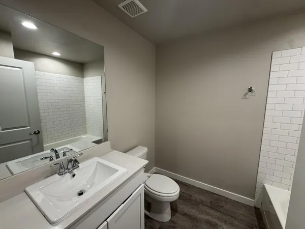 a bathroom with a sink toilet and a mirror