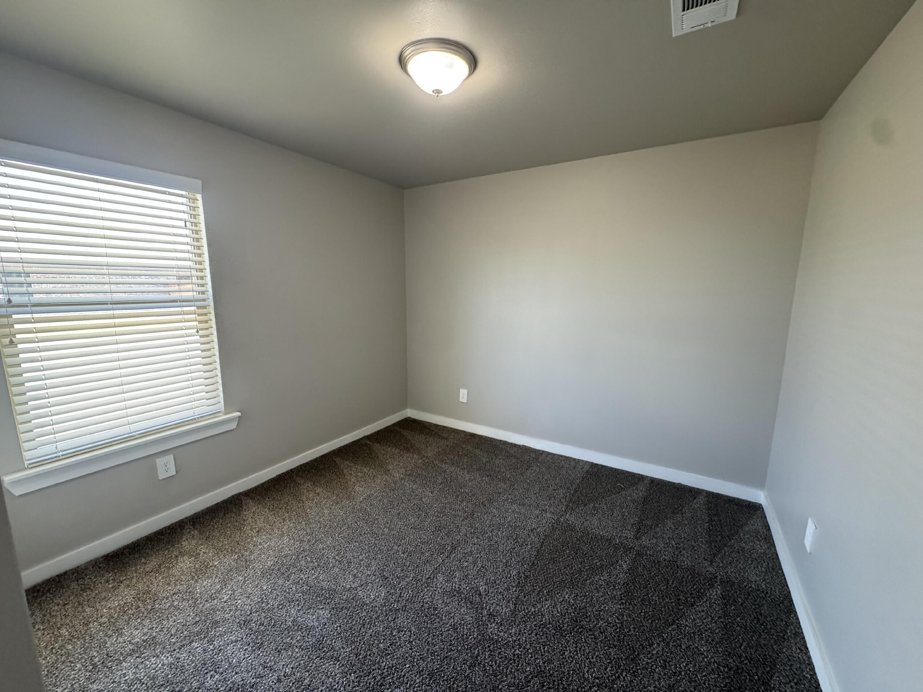 4701 126th Street Lubbock, TX 79424 - Photo 5 of 13 an empty room with a window
