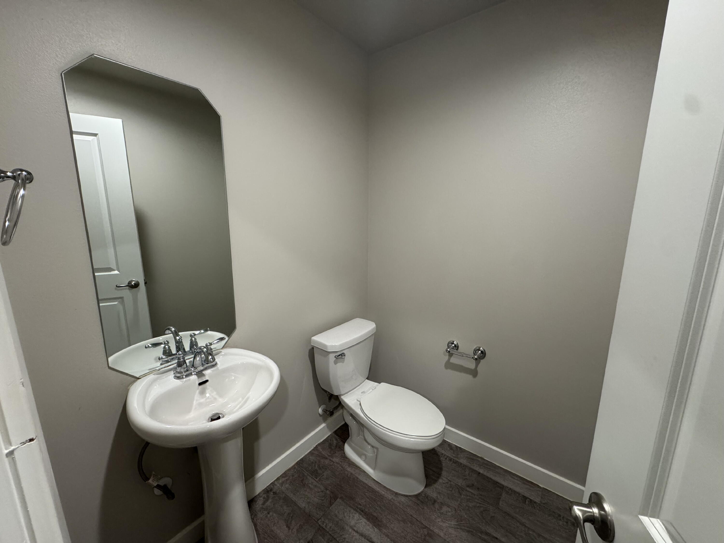 4701 126th Street Lubbock, TX 79424 - Photo 6 of 13 a bathroom with a toilet sink and mirror