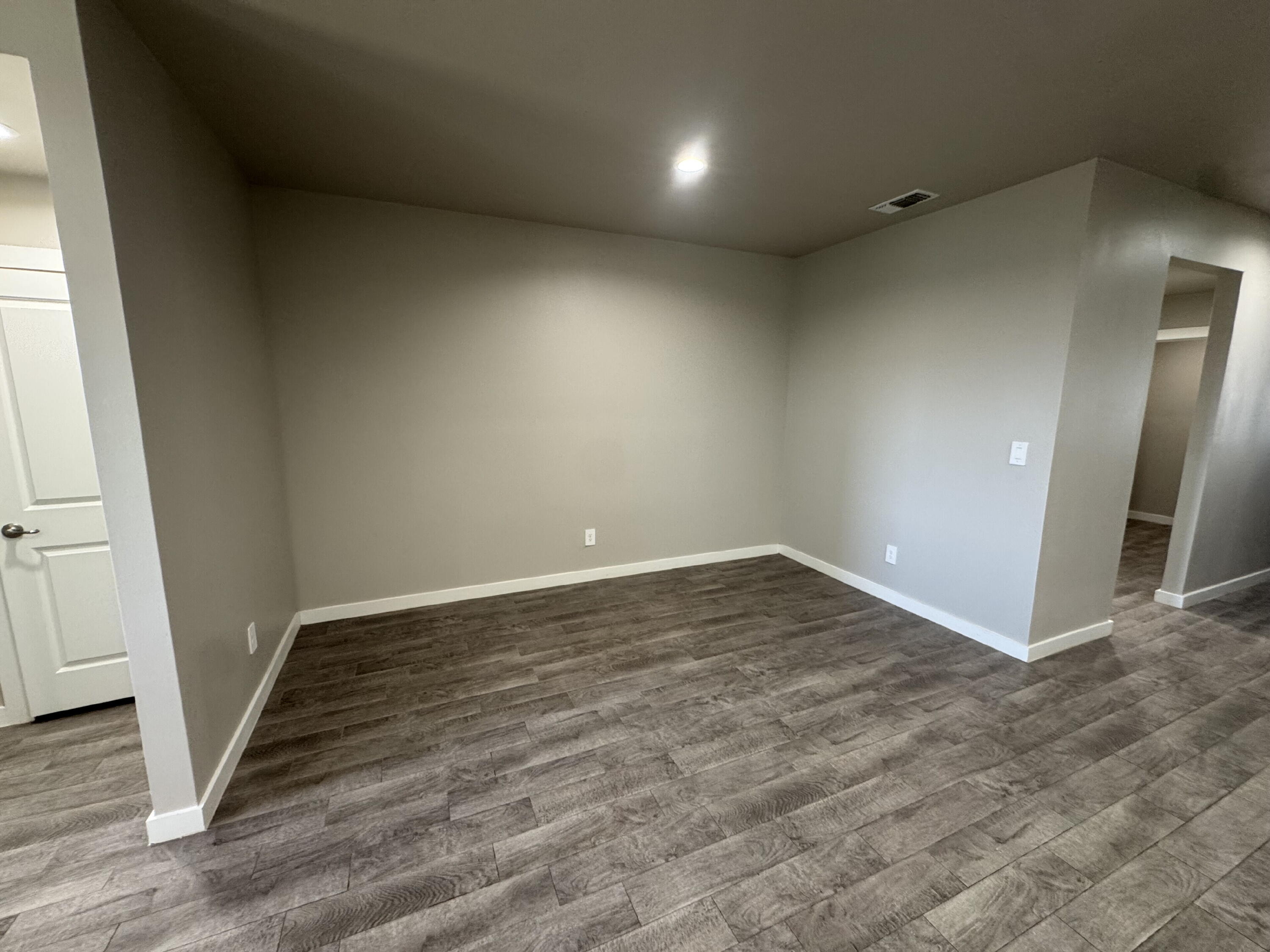 4701 126th Street Lubbock, TX 79424 - Photo 9 of 13 an empty room with wooden floor and entrance