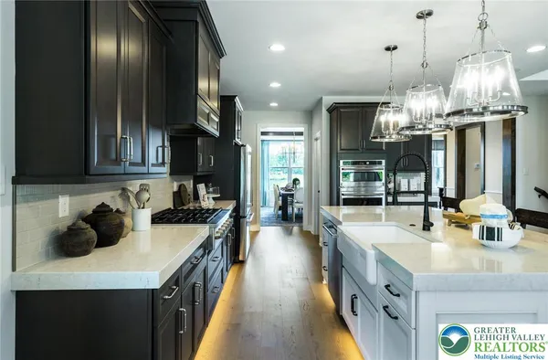 a kitchen with a sink a counter space cabinets and stainless steel appliances