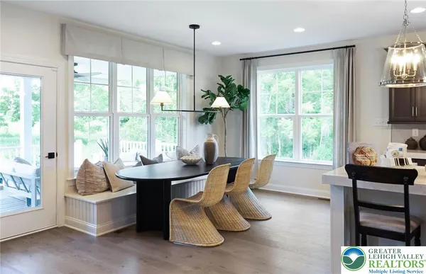 a living room with furniture and large windows