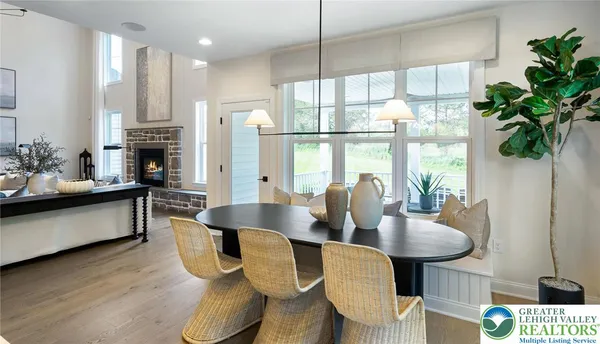 a living room with fireplace furniture and a large window