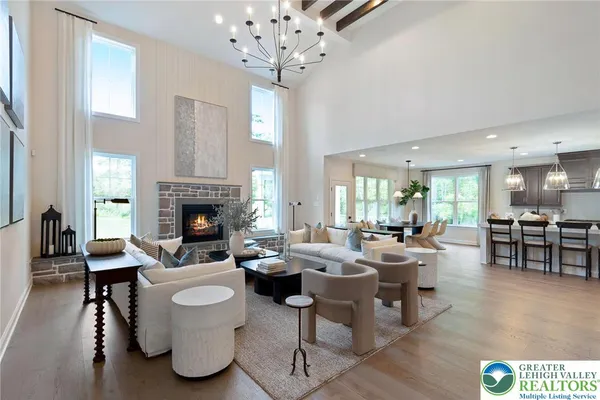 a living room with fireplace furniture and a large window