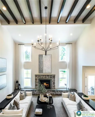 a living room with furniture a large window and a fireplace