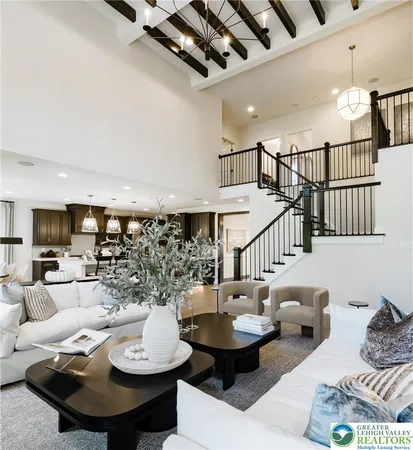 a living room with furniture kitchen view and a table