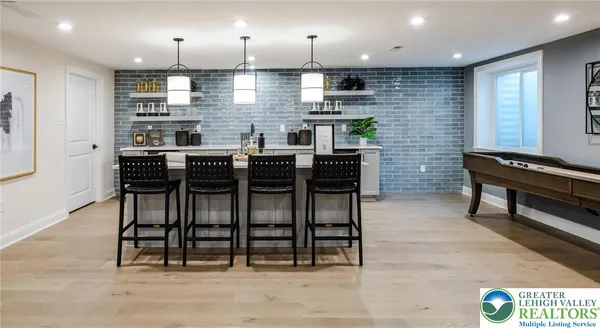 a kitchen with a table chairs stainless steel appliances and cabinets