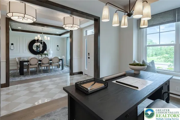 a living room with a table chairs and a window
